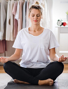 Woman sitting cross-legged in meditation
